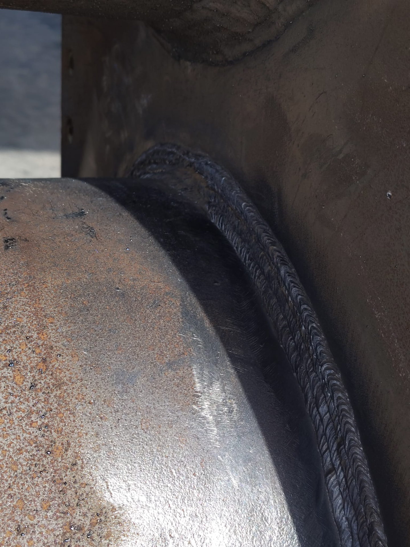 Close-up of a stacked-dime weld bead on a bolted pipe flange